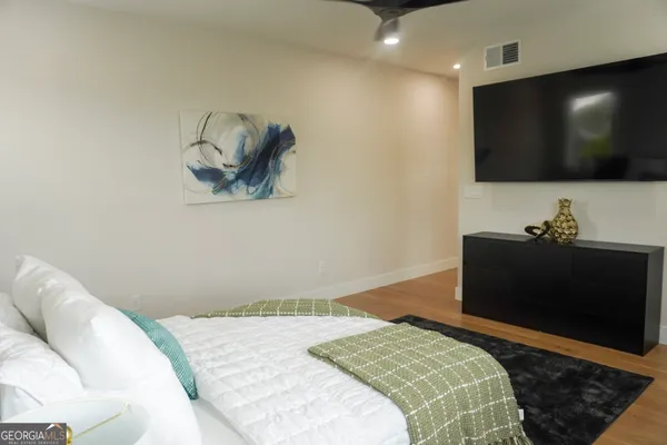 a bedroom with a bed and a flat screen tv