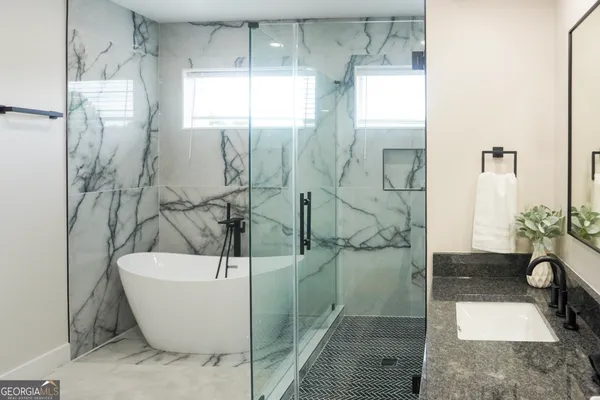 a bathroom with a bathtub and shower