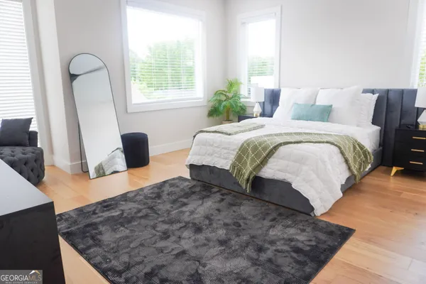 a bedroom with a bed and wooden floor