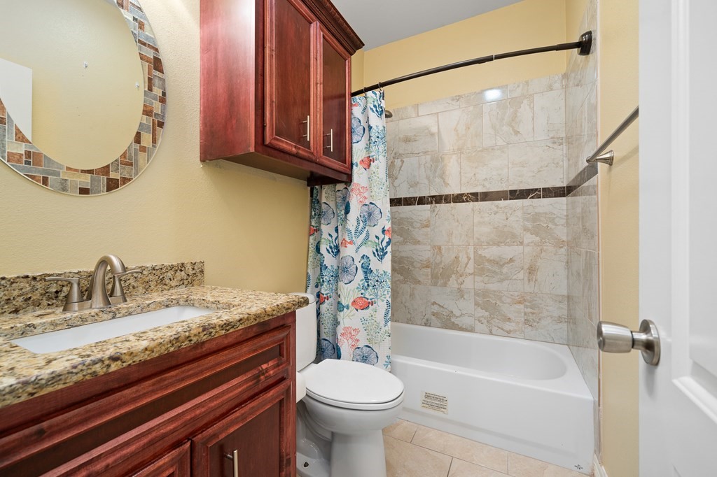 104 Sandollar Circle Fulton, TX 78382 - Photo 11 of 24 a bathroom with a granite countertop sink toilet and shower