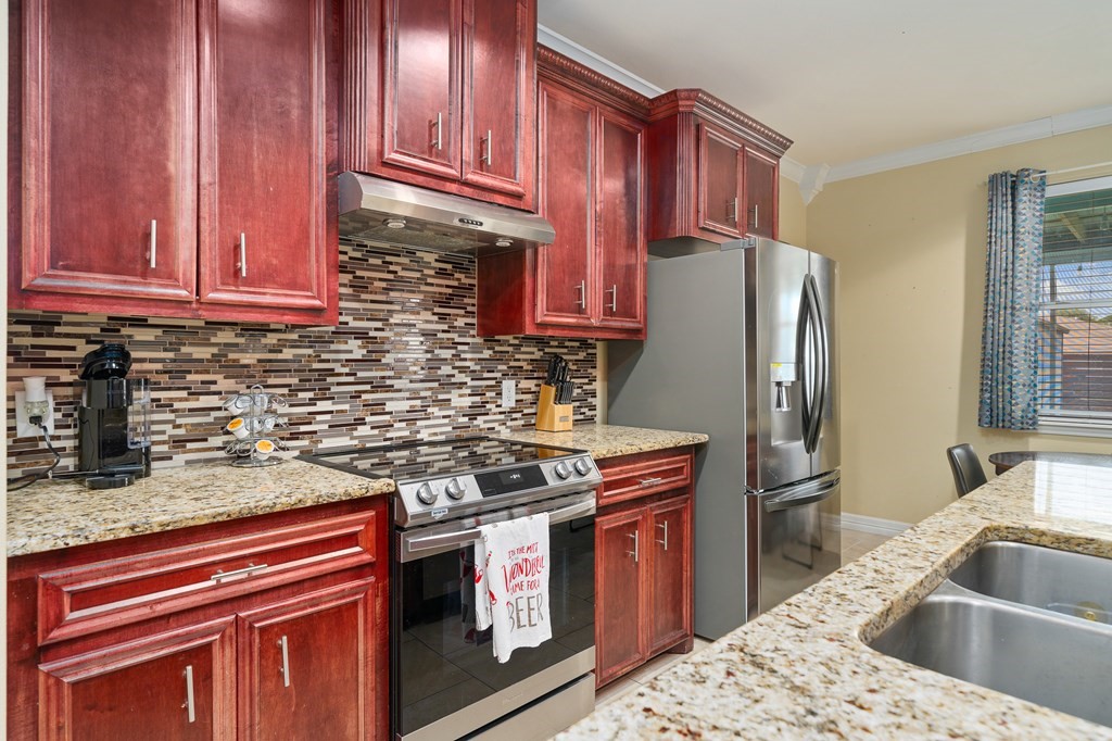 104 Sandollar Circle Fulton, TX 78382 - Photo 4 of 24 a kitchen with stainless steel appliances granite countertop a sink stove and refrigerator