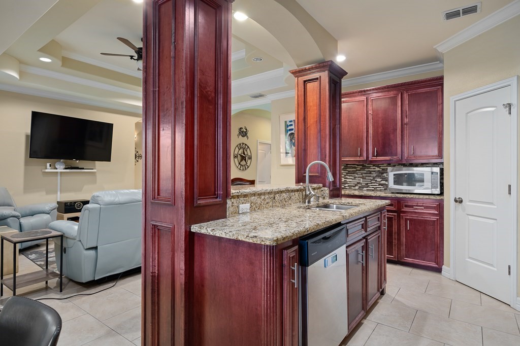 104 Sandollar Circle Fulton, TX 78382 - Photo 5 of 24 a kitchen with stainless steel appliances granite countertop a sink stove and cabinets