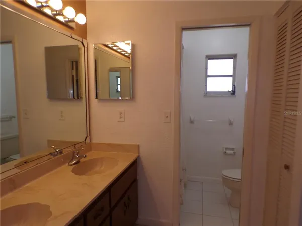 a bathroom with a sink vanity and mirror