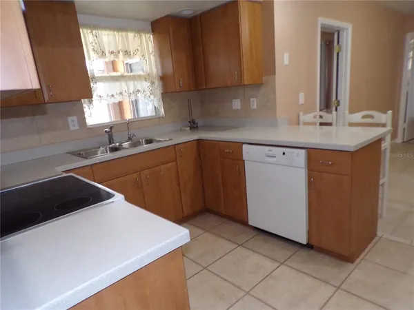 a kitchen with a sink cabinets and window