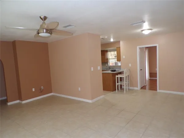 a view of a kitchen with a sink cabinets and a ceiling fan