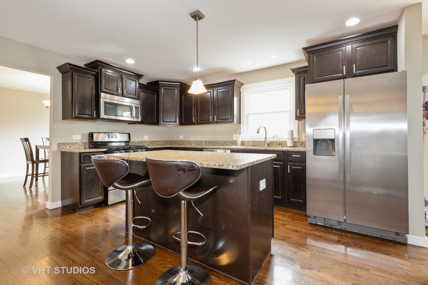 29-w021 Wagner Road Naperville, IL 60564 - Photo 3 of 12 a kitchen with stainless steel appliances granite countertop a sink a stove a refrigerator cabinets and dining table