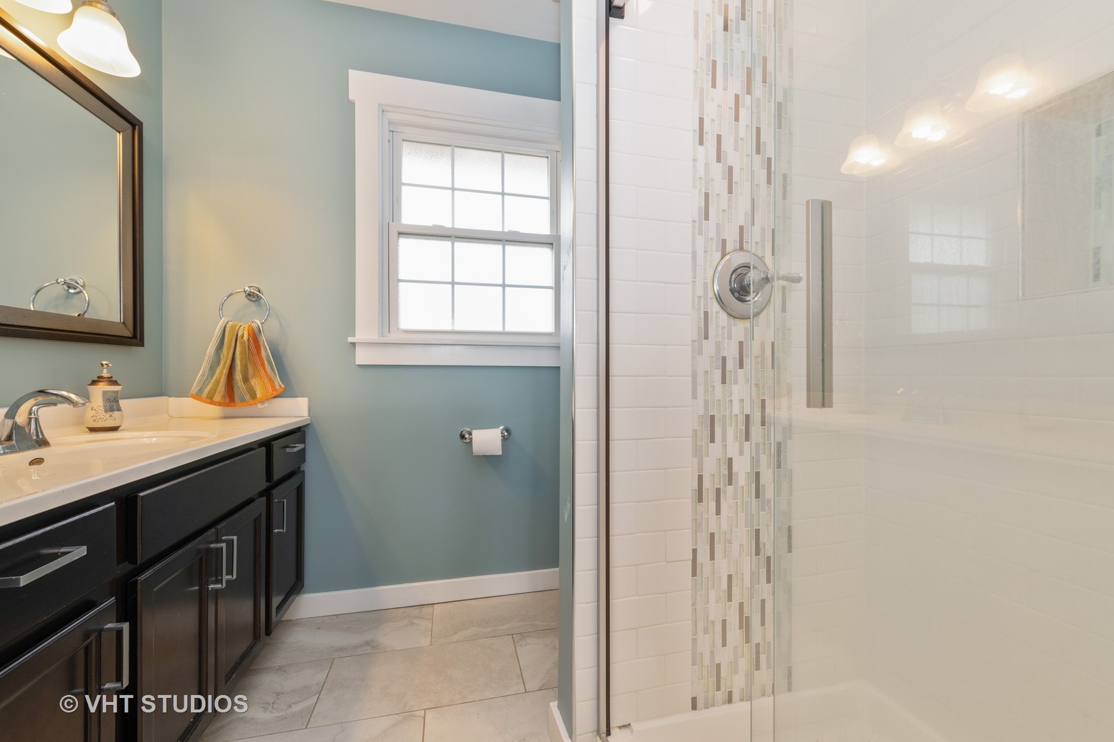 29-w021 Wagner Road Naperville, IL 60564 - Photo 10 of 12 a bathroom with a shower sink and mirror