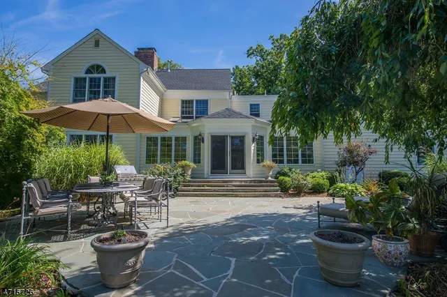 a view of a patio with plants and chairs