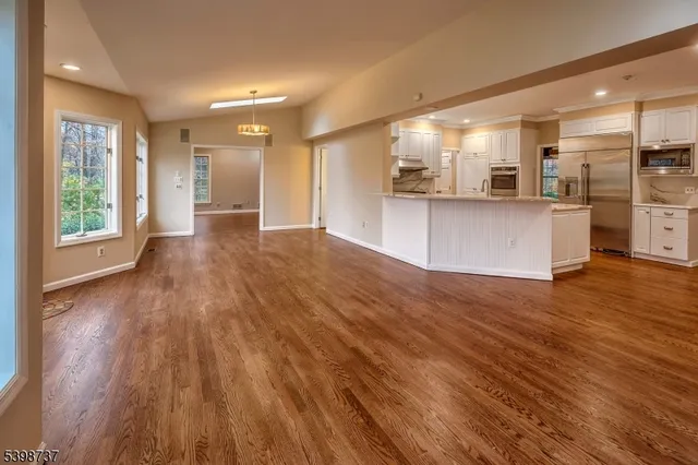 a view of kitchen with cabinets and wooden floor