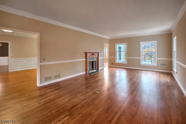 a view of a livingroom with wooden floor and a window