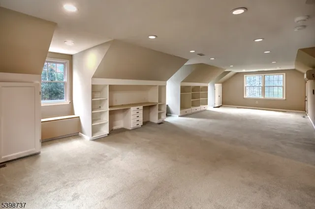 a view of empty room with a fireplace and windows