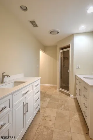 a spacious bathroom with a granite countertop sink a mirror and a