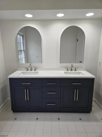 a bathroom with a double vanity sink and a mirror