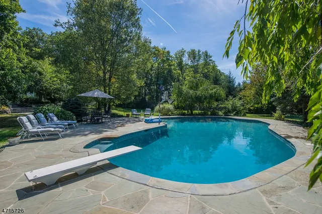 a view of a swimming pool with chairs