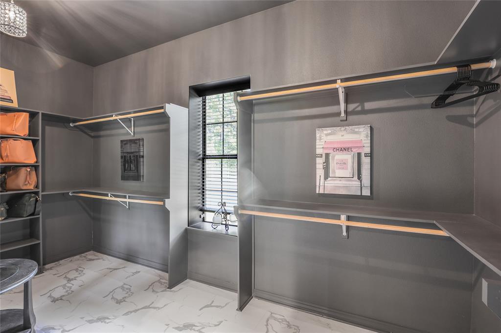 1373 George Ephram Cord 166 Road Overton, TX 75684 - Photo 34 of 40 White and grey marble-look flooring, built-in shelving, two levels of hanging rods, and a window with blinds