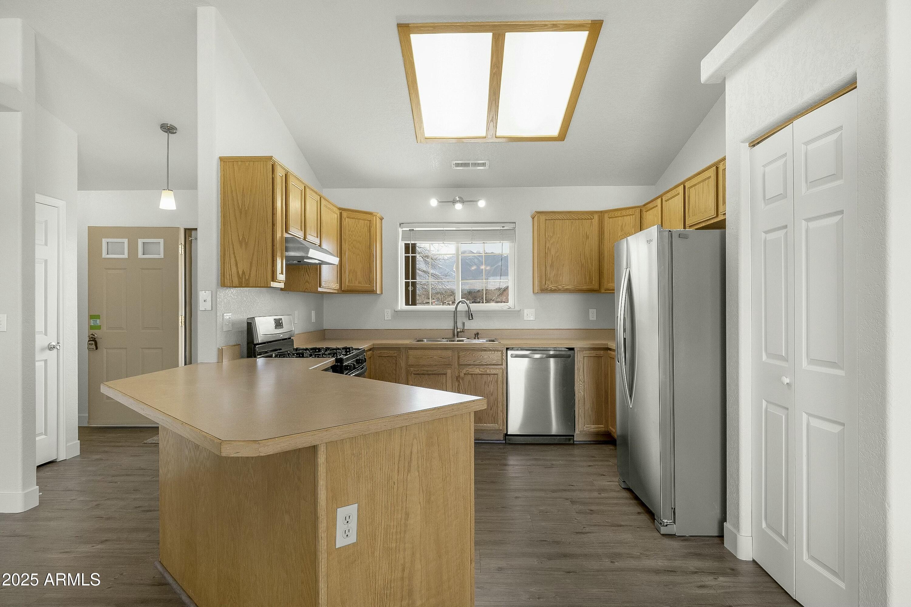8080 Wendy's Way Flagstaff, AZ 86004 - Photo 5 of 18 a kitchen with kitchen island a counter top space a sink stainless steel appliances and cabinets
