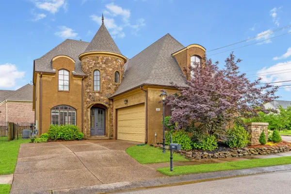 a front view of a house with a garden