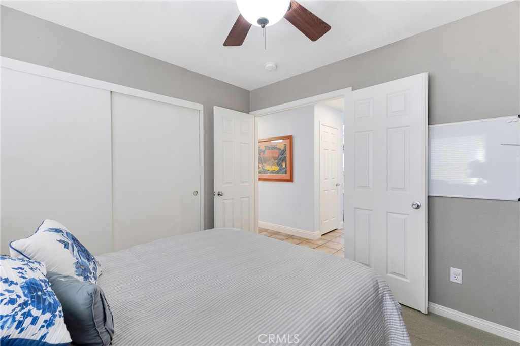 3843 San Gabriel Street Simi Valley, CA 93063 - Photo 28 of 52 a bedroom with a bed and a chandelier