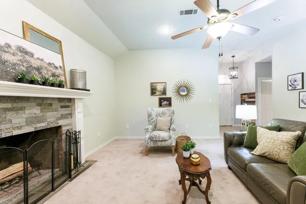 a kitchen with white cabinets appliances and a window