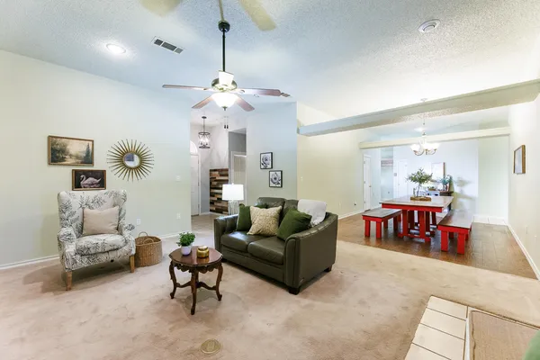 a kitchen with white cabinets a sink stove and wooden floor