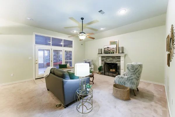 a living room with furniture a chandelier and a fireplace