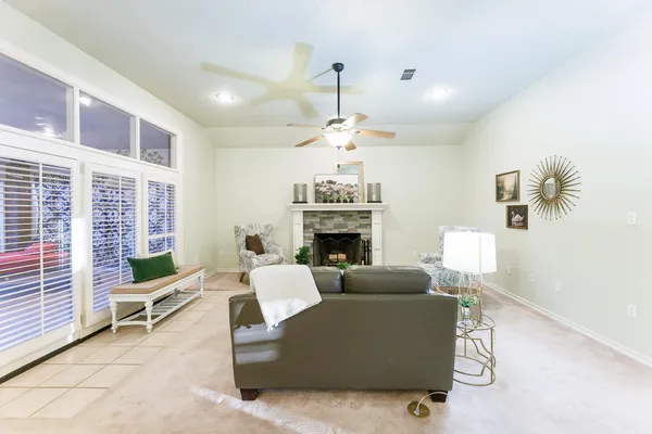 a living room with furniture and a chandelier