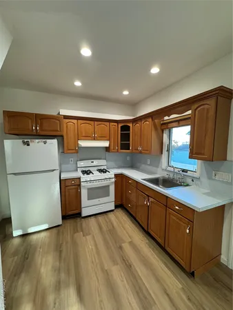 a large kitchen with stainless steel appliances granite countertop a stove a sink dishwasher and a refrigerator