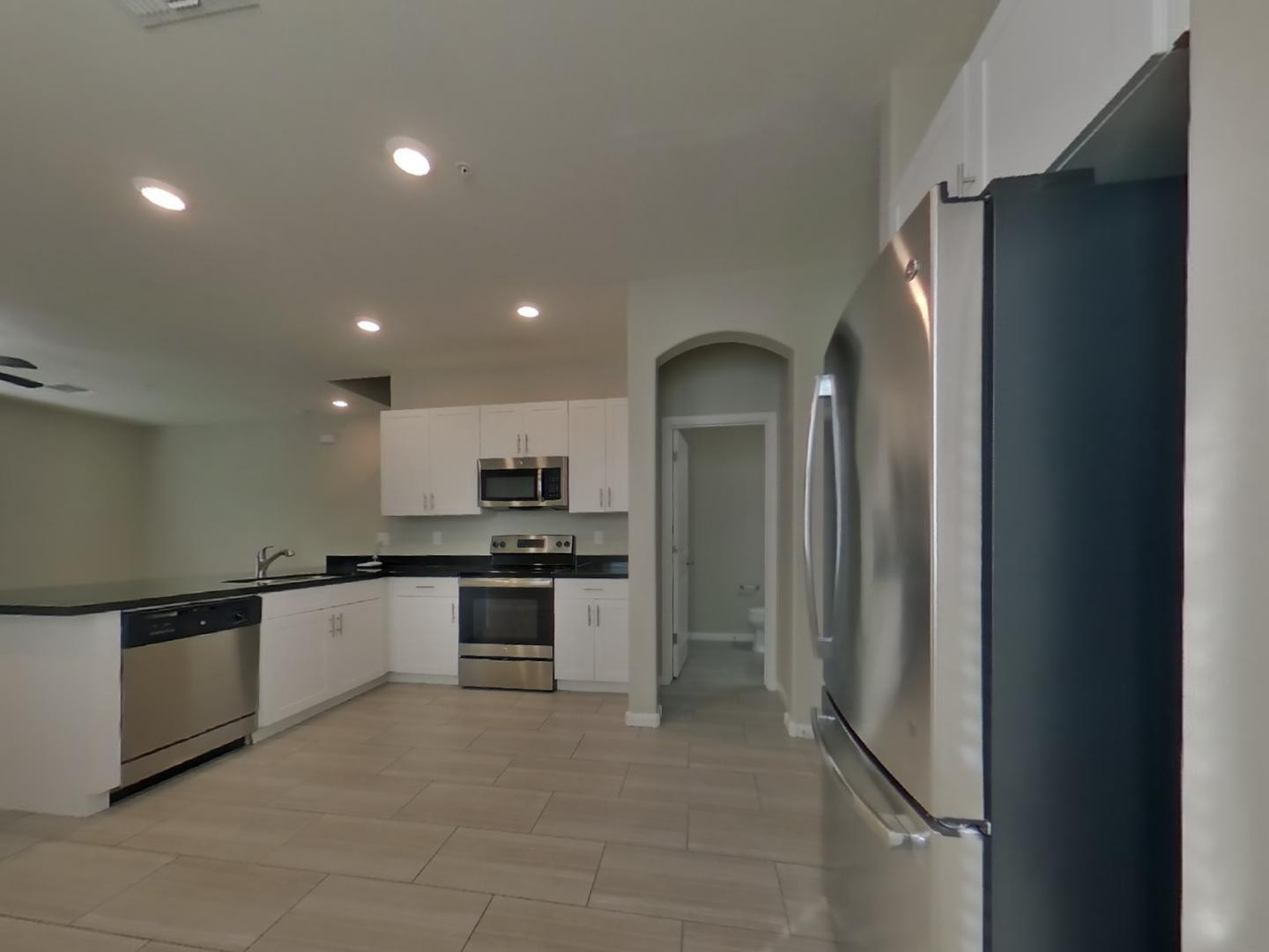 12565 West Via Dona Road Peoria, AZ 85383 - Photo 5 of 17 a large kitchen with stainless steel appliances granite countertop a refrigerator and a stove