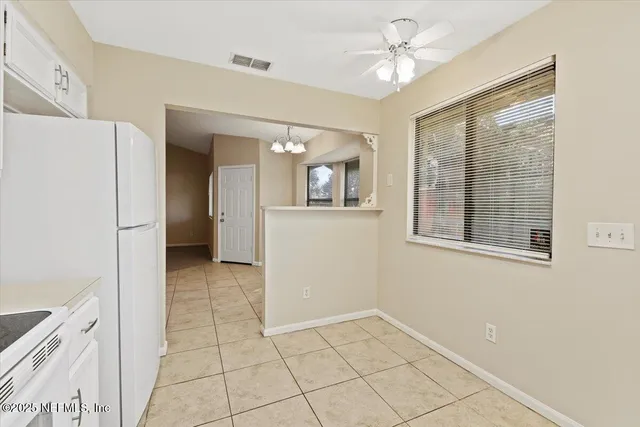 a white refrigerator freezer and a stove in a kitchen