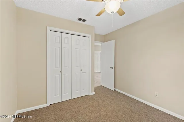 an empty room with a ceiling fan