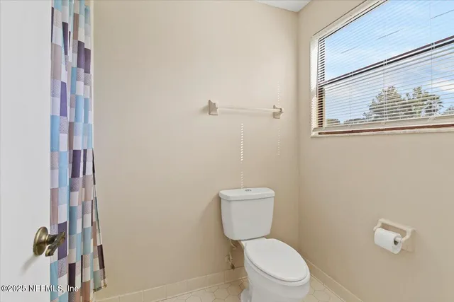 a white toilet sitting next to a bathroom sink