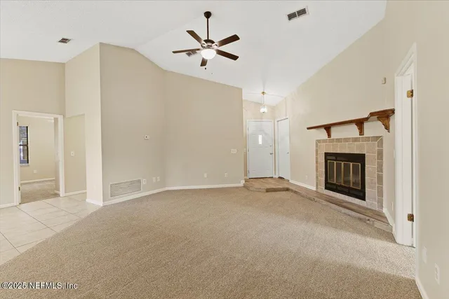 a view of a livingroom with a ceiling fan and window