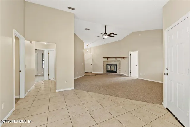 a view of an empty room with a fireplace
