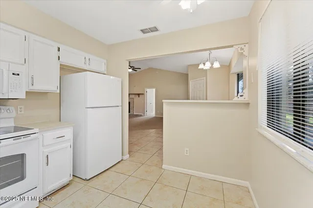 a kitchen with cabinets stainless steel appliances and sink