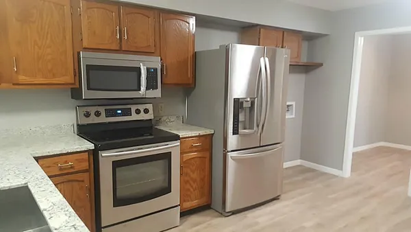 a kitchen with a stove microwave and refrigerator