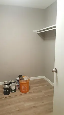 a room with a wooden floor and a sink