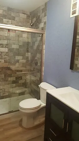 a white toilet sitting next to a bathroom sink