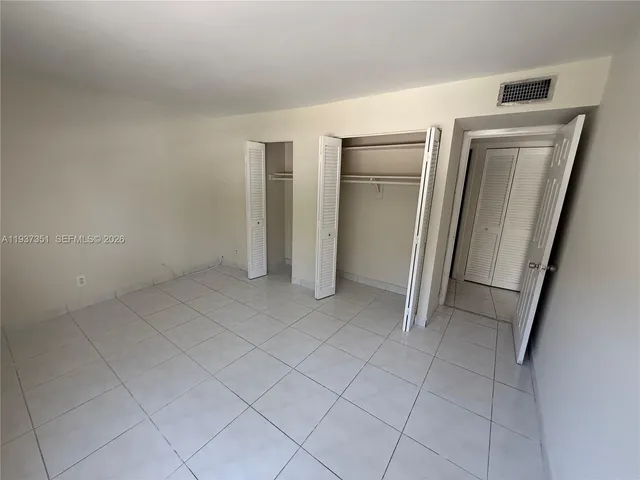 a bathroom with a granite countertop sink a mirror and a bathtub