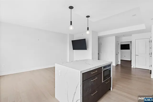 a kitchen with a sink a microwave and cabinets