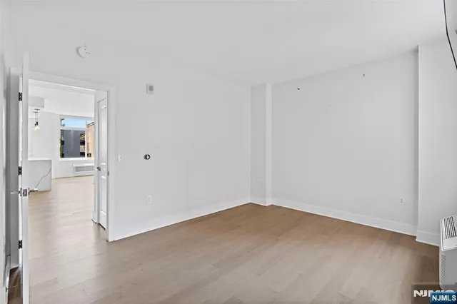 a view of a room with wooden floor