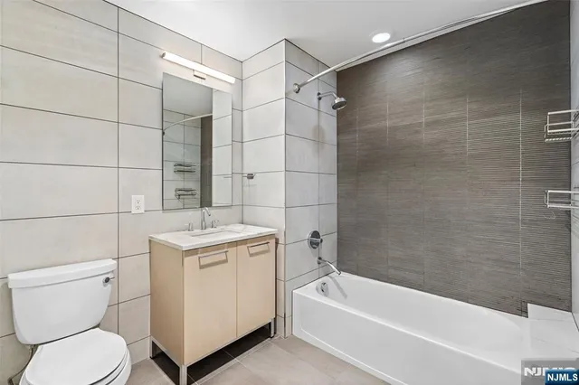 a bathroom with a sink a toilet and bathtub