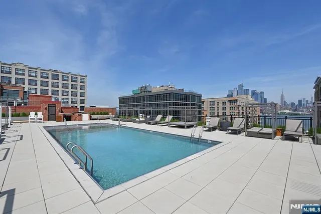 a view of outdoor space with swimming pool and seating