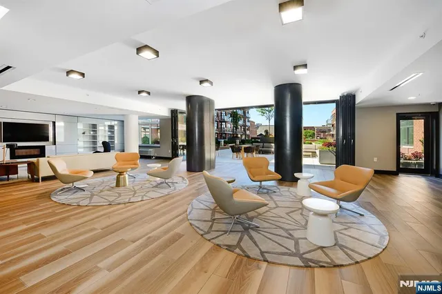 a living room with lots of furniture and a view of kitchen