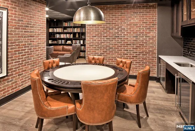 a living room with furniture a rug and a book shelf