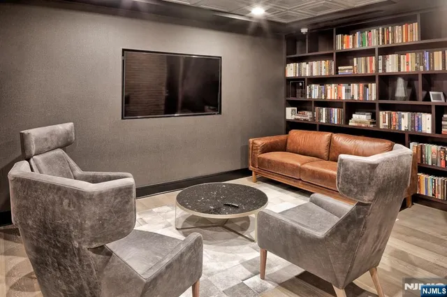 a kitchen with stainless steel appliances granite countertop a sink and a refrigerator