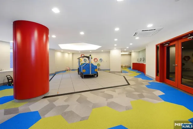 a kitchen with stainless steel appliances kitchen island granite countertop a stove and a cabinets