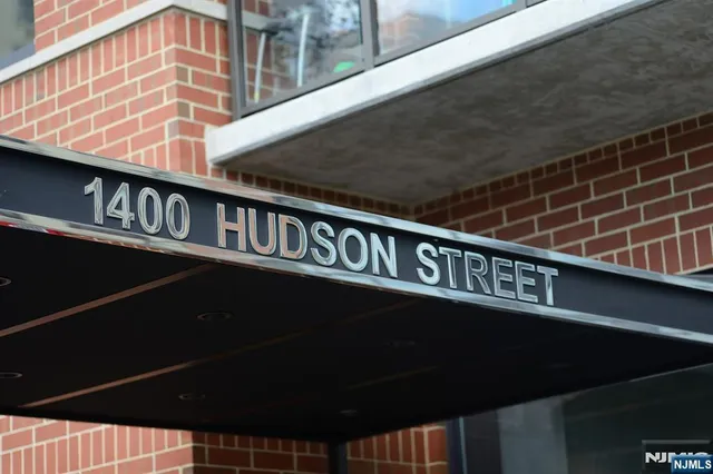 a view of a tall building next to a road