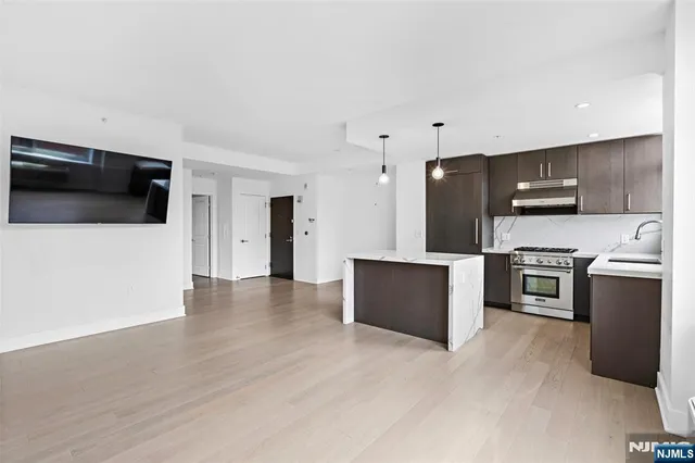 a view of kitchen with stainless steel appliances kitchen island microwave and stove