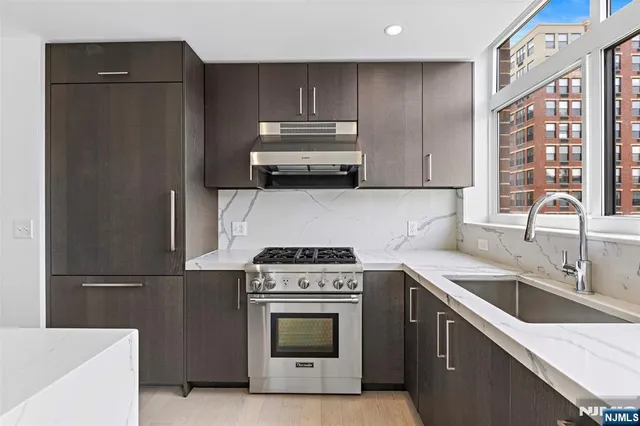a kitchen with a sink stove and refrigerator