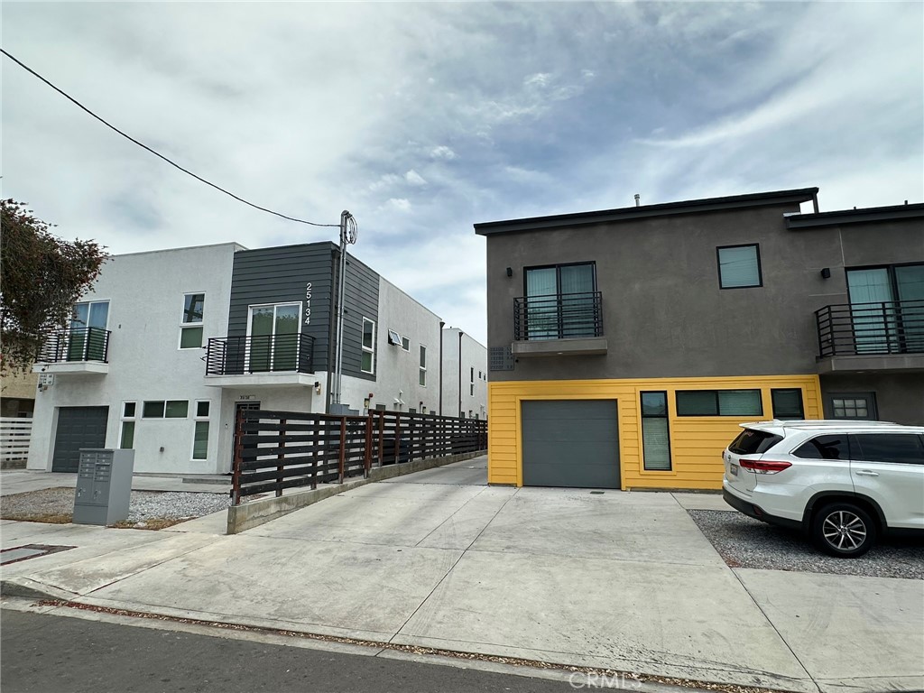 25134-25200 Frampton Avenue Harbor City, CA 90710 - Photo 1 of 11 a front view of a house with a garage
